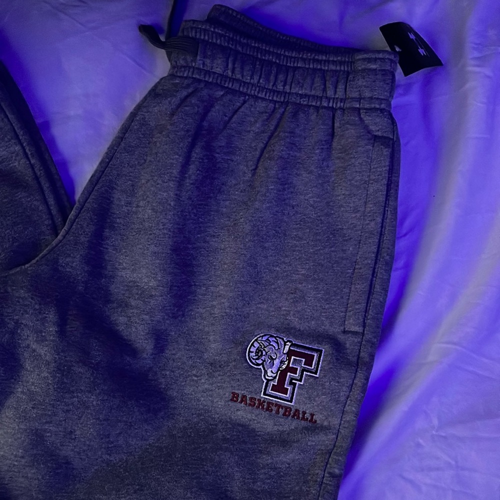 Under Armour sweat pants with tapered pant legs with Fordham basketball logo.